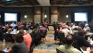 Entrinsik customers in large ballroom listening to presentation